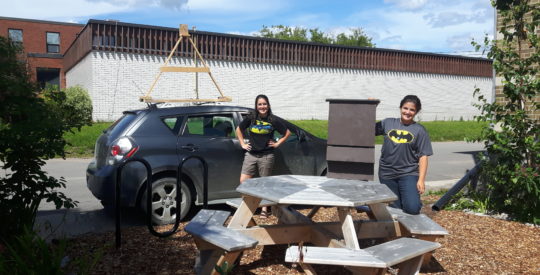 Delaina Arnold and Tianna Burke in front of the bat mobile and a bat house. Credit D Bywater